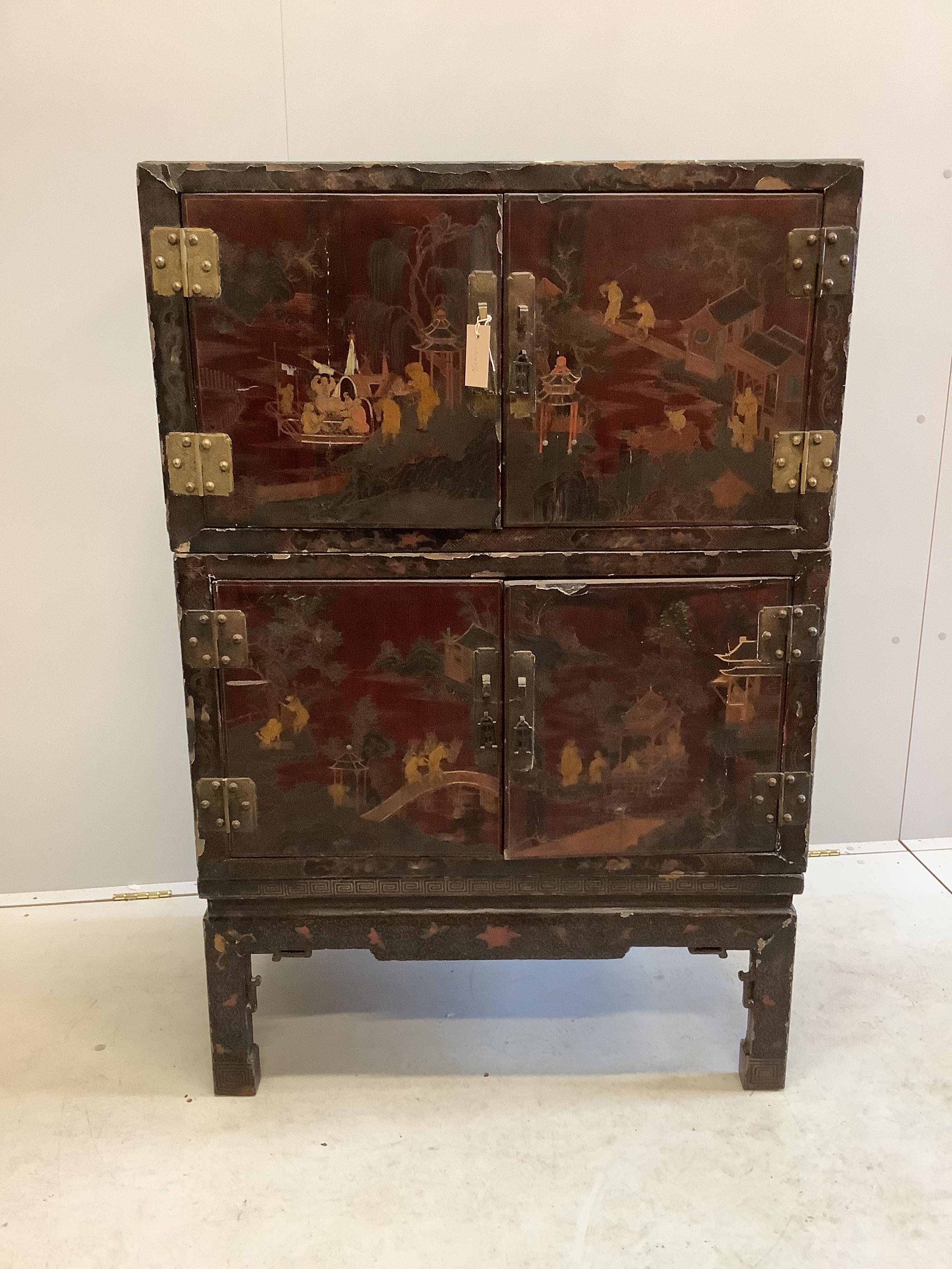 A Chinese lacquered two section cabinet on stand, width 84cm, depth 51cm, height 128cm